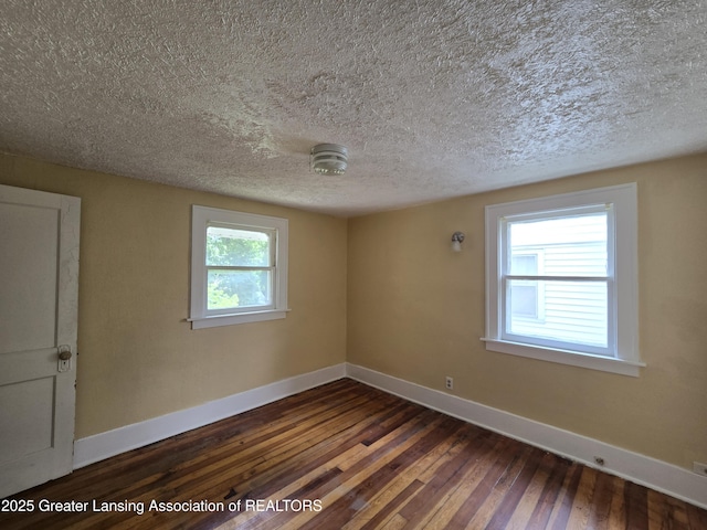 812 Westmoreland Ave, Lansing, MI 48915 - spare room with baseboards, dark wood finished floors, and a textured ceiling