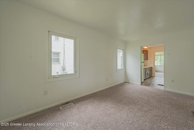 629 Emily Ave, Lansing, MI 48910 - unfurnished room with light carpet and baseboards