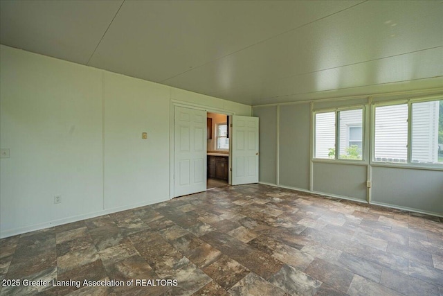 629 Emily Ave, Lansing, MI 48910 - unfurnished room with stone finish flooring and baseboards