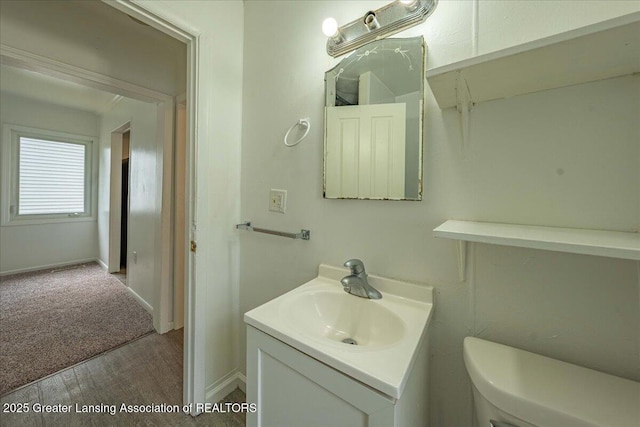 629 Emily Ave, Lansing, MI 48910 - bathroom featuring vanity, wood finished floors, toilet, and baseboards