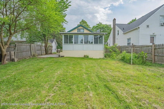 629 Emily Ave, Lansing, MI 48910 - rear view of house featuring a sunroom and a chimney