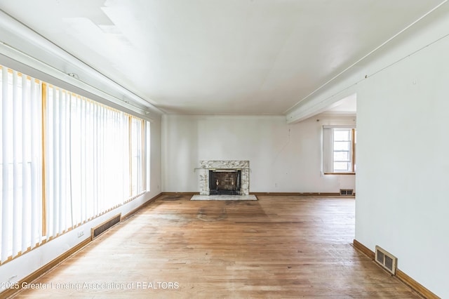 19326 Marlowe St, Detroit, MI 48235 - unfurnished living room with a high end fireplace, light wood finished floors, and ornamental molding