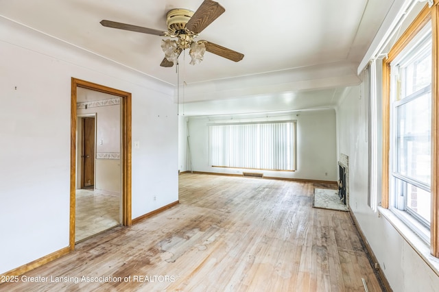 19326 Marlowe St, Detroit, MI 48235 - empty room featuring plenty of natural light, ceiling fan, wood finished floors, and a high end fireplace