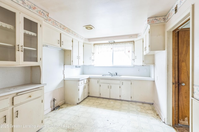 19326 Marlowe St, Detroit, MI 48235 - kitchen featuring light floors, light countertops, and glass insert cabinets