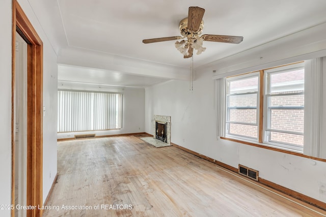 19326 Marlowe St, Detroit, MI 48235 - unfurnished living room with plenty of natural light, a premium fireplace, light wood-style floors, and ceiling fan