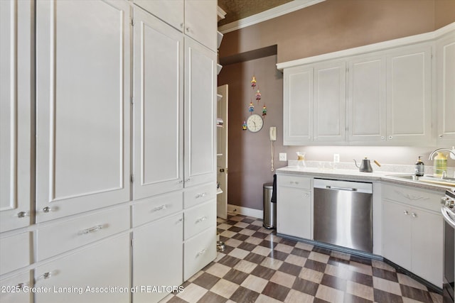 1035 N Capitol Ave, Lansing, MI 48906 - kitchen with stainless steel dishwasher, white cabinetry, light countertops, and crown molding