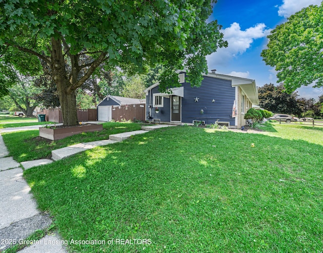 3701 Jerree St, Lansing, MI 48911 - view of yard featuring a detached garage, driveway, and an outdoor structure