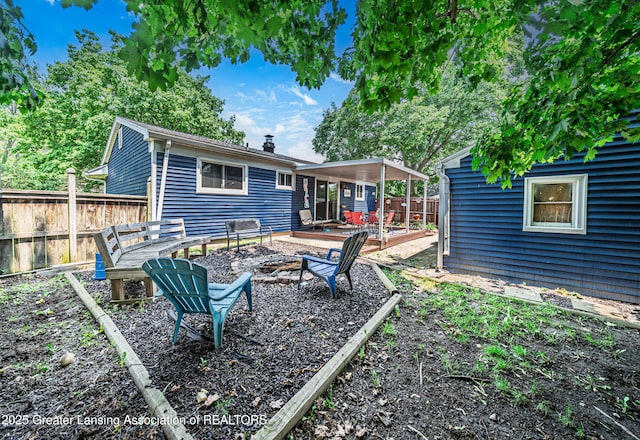 3701 Jerree St, Lansing, MI 48911 - rear view of property featuring a fire pit and a wooden deck