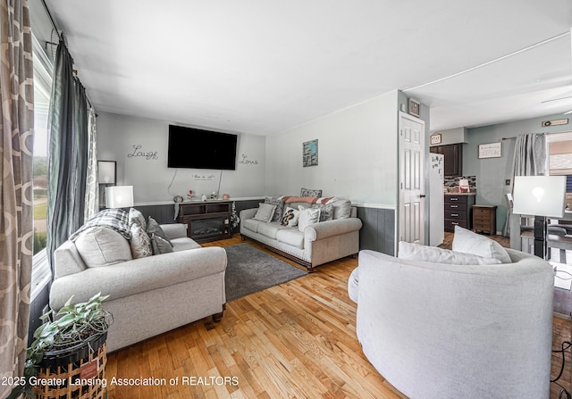 3701 Jerree St, Lansing, MI 48911 - living area with light wood finished floors and a wainscoted wall