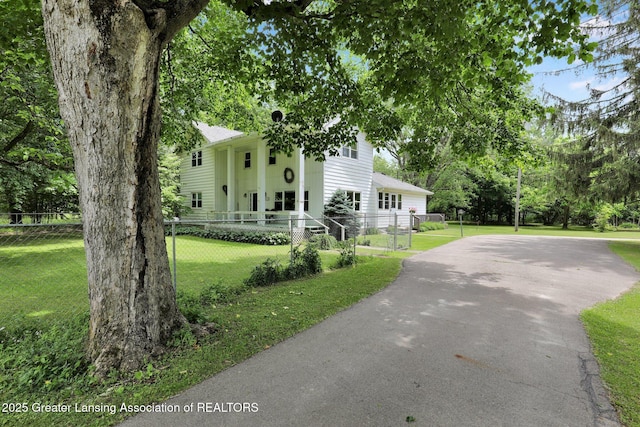 8767 Corrison Rd, Grand Ledge, MI 48837 - neoclassical / greek revival house featuring asphalt driveway and a fenced front yard