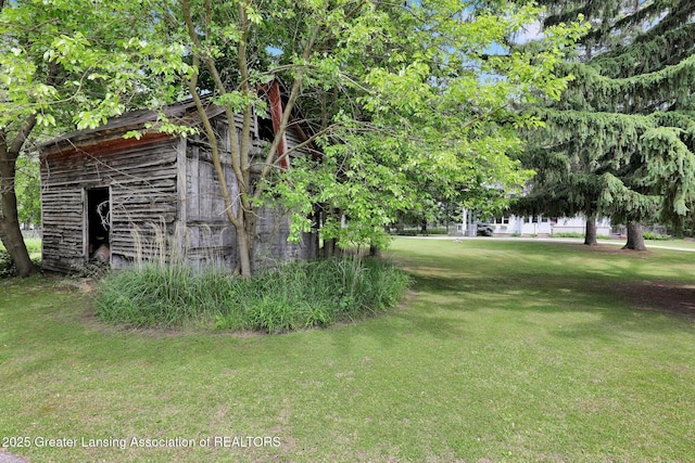 8767 Corrison Rd, Grand Ledge, MI 48837 - view of green lawn with an outdoor structure
