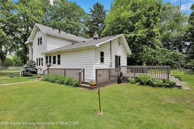 8767 Corrison Rd, Grand Ledge, MI 48837 - view of home's exterior with a wooden deck, a chimney, and a shingled roof