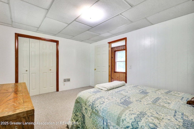 8767 Corrison Rd, Grand Ledge, MI 48837 - bedroom with carpet flooring, a closet, and a paneled ceiling
