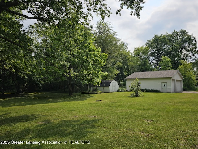 8767 Corrison Rd, Grand Ledge, MI 48837 - view of green lawn with a shed