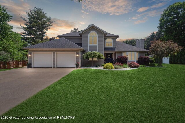 2020 Sunset Dr, Owosso, MI 48867 - traditional home with a chimney, driveway, an attached garage, and a shingled roof