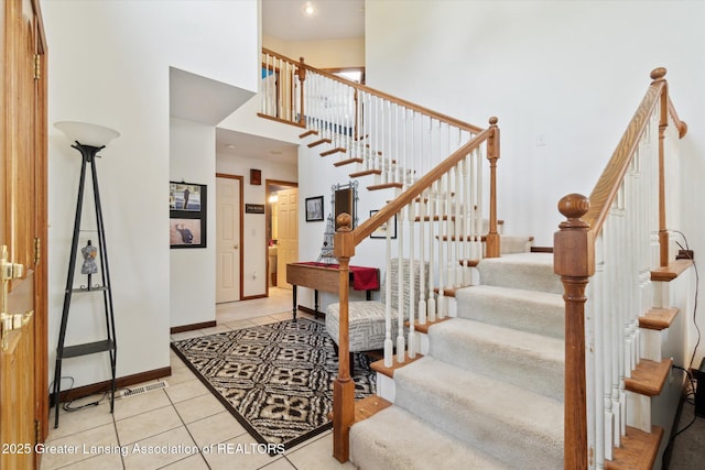 2020 Sunset Dr, Owosso, MI 48867 - staircase with tile patterned flooring and a high ceiling