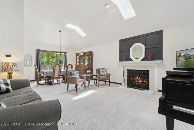 2020 Sunset Dr, Owosso, MI 48867 - living room with a skylight, light colored carpet, a tile fireplace, and high vaulted ceiling