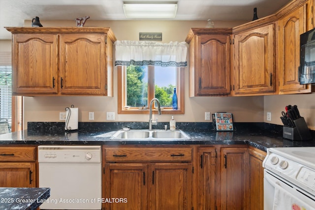 2020 Sunset Dr, Owosso, MI 48867 - kitchen featuring white appliances, brown cabinetry, and dark stone countertops