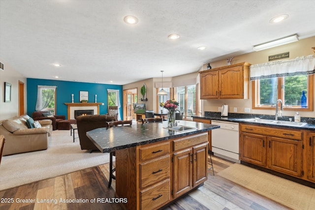 2020 Sunset Dr, Owosso, MI 48867 - kitchen featuring white dishwasher, a breakfast bar area, healthy amount of natural light, light wood-style flooring, and recessed lighting
