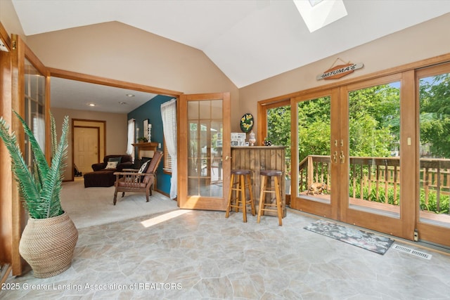 2020 Sunset Dr, Owosso, MI 48867 - sunroom featuring a skylight, lofted ceiling, and french doors