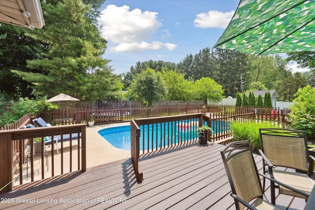 2020 Sunset Dr, Owosso, MI 48867 - view of pool featuring a fenced backyard, a wooden deck, and a patio