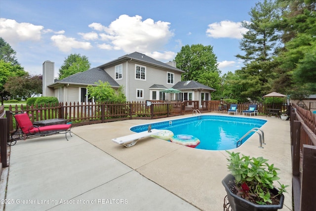 2020 Sunset Dr, Owosso, MI 48867 - view of pool featuring a patio, a deck, and a diving board