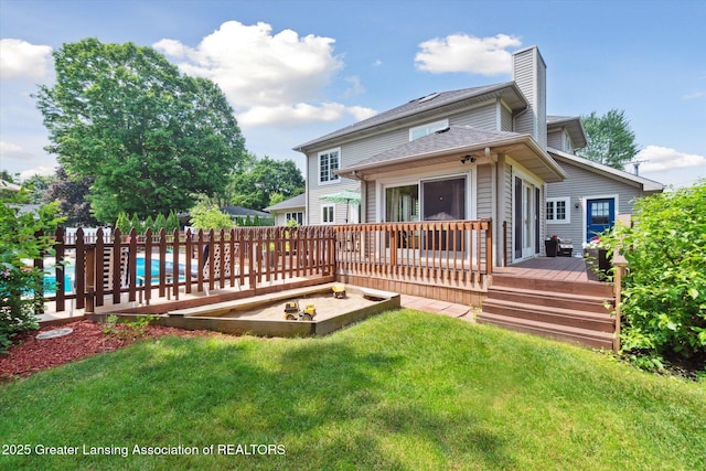 2020 Sunset Dr, Owosso, MI 48867 - back of property featuring a deck and a chimney