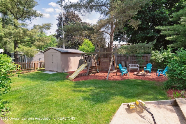 2020 Sunset Dr, Owosso, MI 48867 - fenced backyard with an outdoor fire pit, a playground, and a storage shed