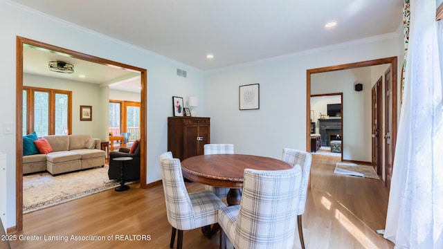 1117 Windreef Cir, Okemos, MI 48864 - dining space featuring wood finished floors, crown molding, french doors, and recessed lighting