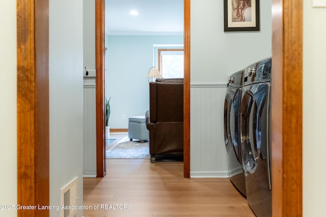 1117 Windreef Cir, Okemos, MI 48864 - laundry area with washing machine and clothes dryer, wood finished floors, and crown molding