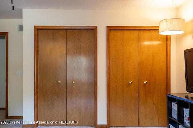 1117 Windreef Cir, Okemos, MI 48864 - unfurnished bedroom with multiple closets and baseboards