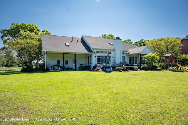 10464 Hankerd Rd, Pleasant Lake, MI 49272 - rear view of property with a playground, a chimney, a shingled roof, and a wooden deck