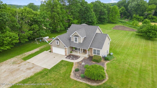 4905 E Green Rd, Saint Johns, MI 48879 - view of front of house featuring driveway, stone siding, a porch, and a front lawn