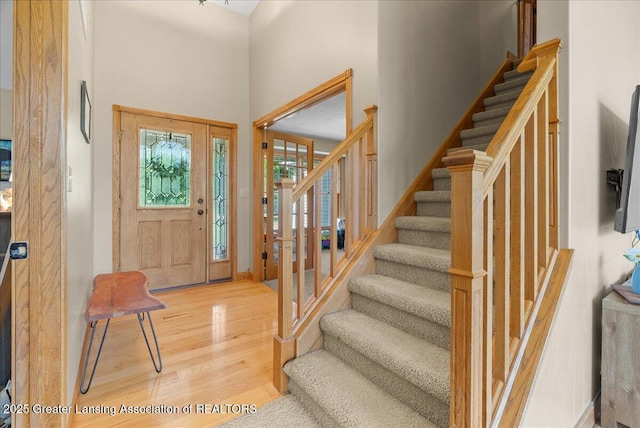 4905 E Green Rd, Saint Johns, MI 48879 - foyer entrance featuring light wood finished floors, stairway, and a towering ceiling