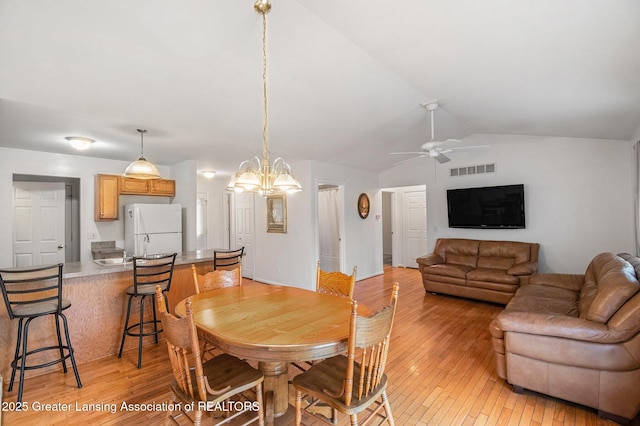 1262 Evans St, Mason, MI 48854 - dining room with light wood-style flooring, ceiling fan, lofted ceiling, and a chandelier