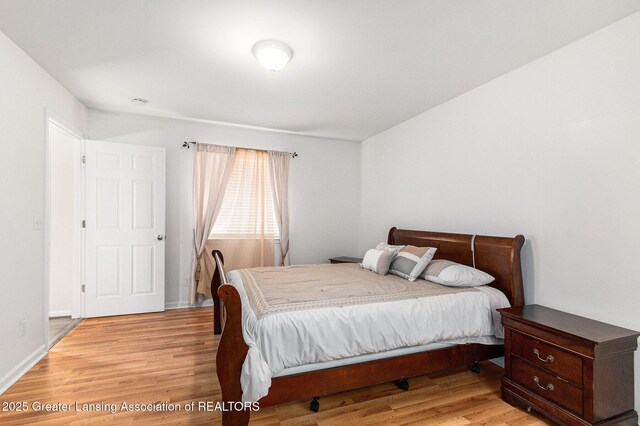 1262 Evans St, Mason, MI 48854 - bedroom with light wood-style floors and baseboards