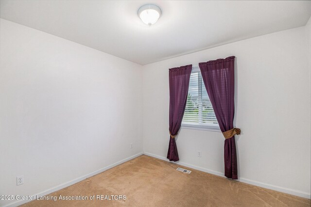 1262 Evans St, Mason, MI 48854 - empty room with light colored carpet and baseboards