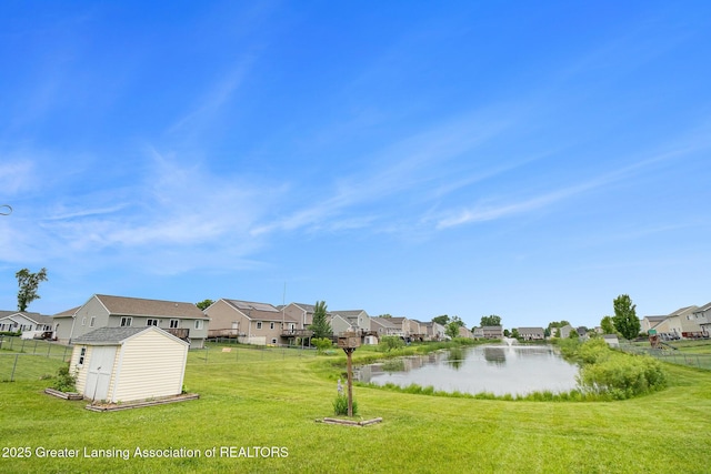 1262 Evans St, Mason, MI 48854 - view of yard with a residential view, a storage unit, and a water view