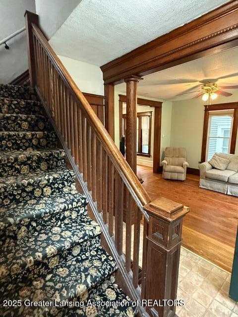 921 W Genesee St, Lansing, MI 48915 - staircase featuring a ceiling fan and a textured ceiling