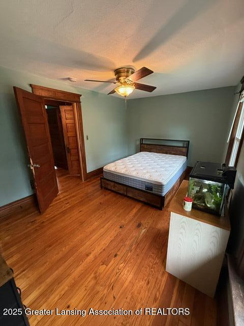 921 W Genesee St, Lansing, MI 48915 - bedroom with light wood finished floors and ceiling fan