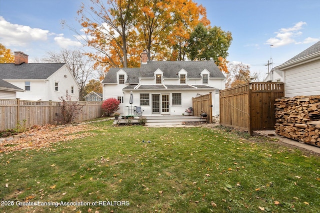 350 N Marshall Ave, Marshall, MI 49068 - rear view of house featuring a fenced backyard, a wooden deck, a chimney, and roof with shingles