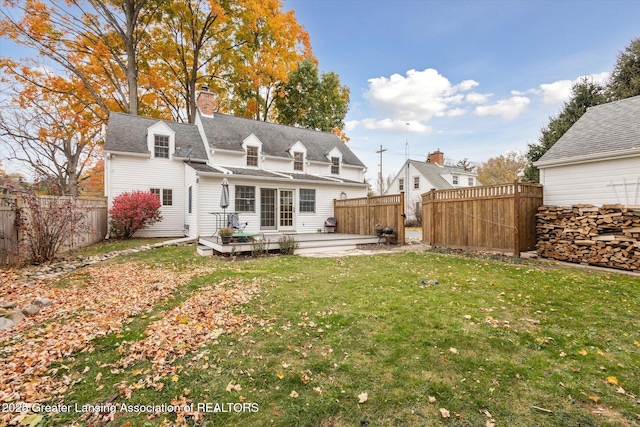 350 N Marshall Ave, Marshall, MI 49068 - back of house with a deck, a chimney, a fenced backyard, and roof with shingles