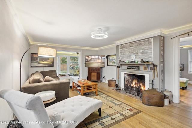 350 N Marshall Ave, Marshall, MI 49068 - living room with ornamental molding, light wood-style flooring, and a warm lit fireplace