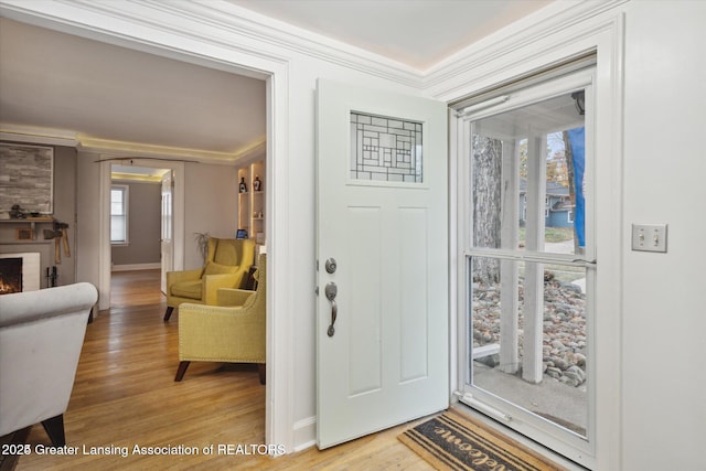 350 N Marshall Ave, Marshall, MI 49068 - foyer entrance featuring light wood finished floors, crown molding, and a fireplace