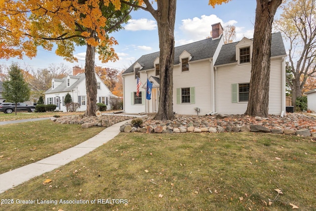 350 N Marshall Ave, Marshall, MI 49068 - view of front of property featuring a front lawn, a chimney, and a shingled roof