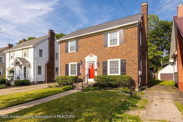 720 N Fairview Ave, Lansing, MI 48912 - colonial inspired home with a front lawn, brick siding, and a chimney
