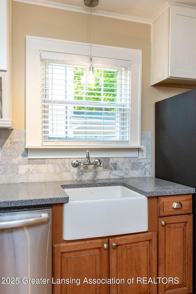 720 N Fairview Ave, Lansing, MI 48912 - kitchen with dishwasher, brown cabinetry, ornamental molding, and decorative light fixtures