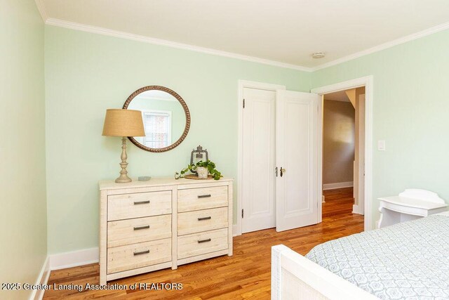 720 N Fairview Ave, Lansing, MI 48912 - bedroom with light wood-type flooring and crown molding