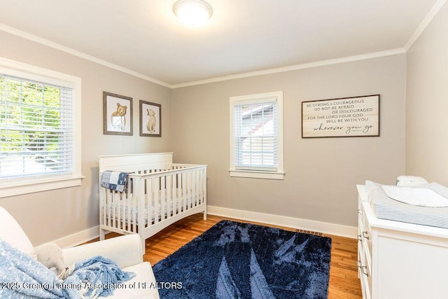 720 N Fairview Ave, Lansing, MI 48912 - bedroom featuring crown molding, light wood finished floors, and multiple windows