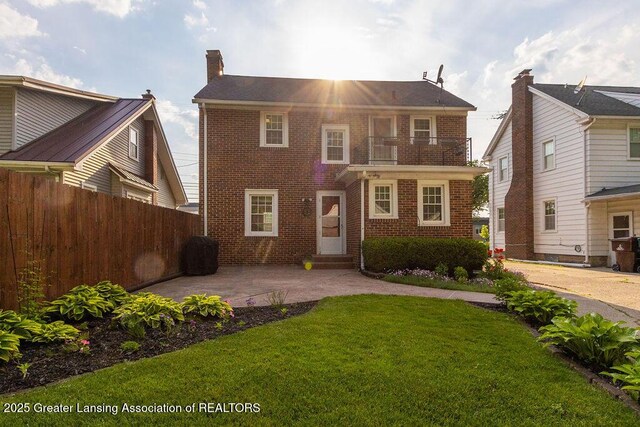 720 N Fairview Ave, Lansing, MI 48912 - view of front facade featuring brick siding, a balcony, a patio, and entry steps